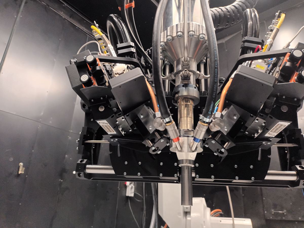 LACS process cell — multi-axis laser optics and nozzle assembly